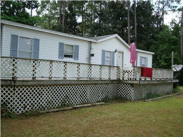 a backyard of a house with wooden fence
