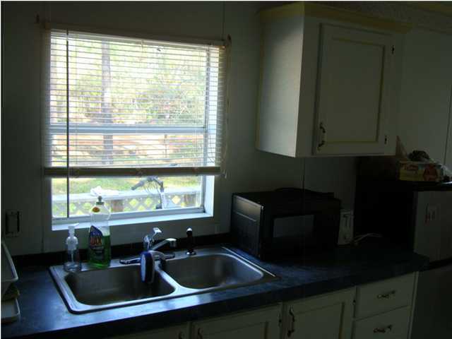 179 13th Street Santa Rosa Beach, FL 32459 - Photo 3 of 21 a kitchen with a sink a counter space and a window
