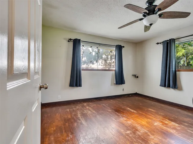 an empty room with windows and closet