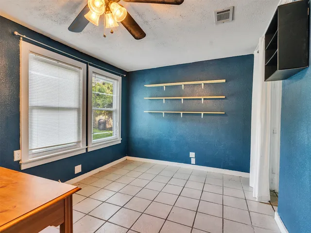 a view of a livingroom with an empty space and a window