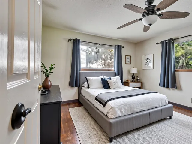 a bedroom with bed and a large window