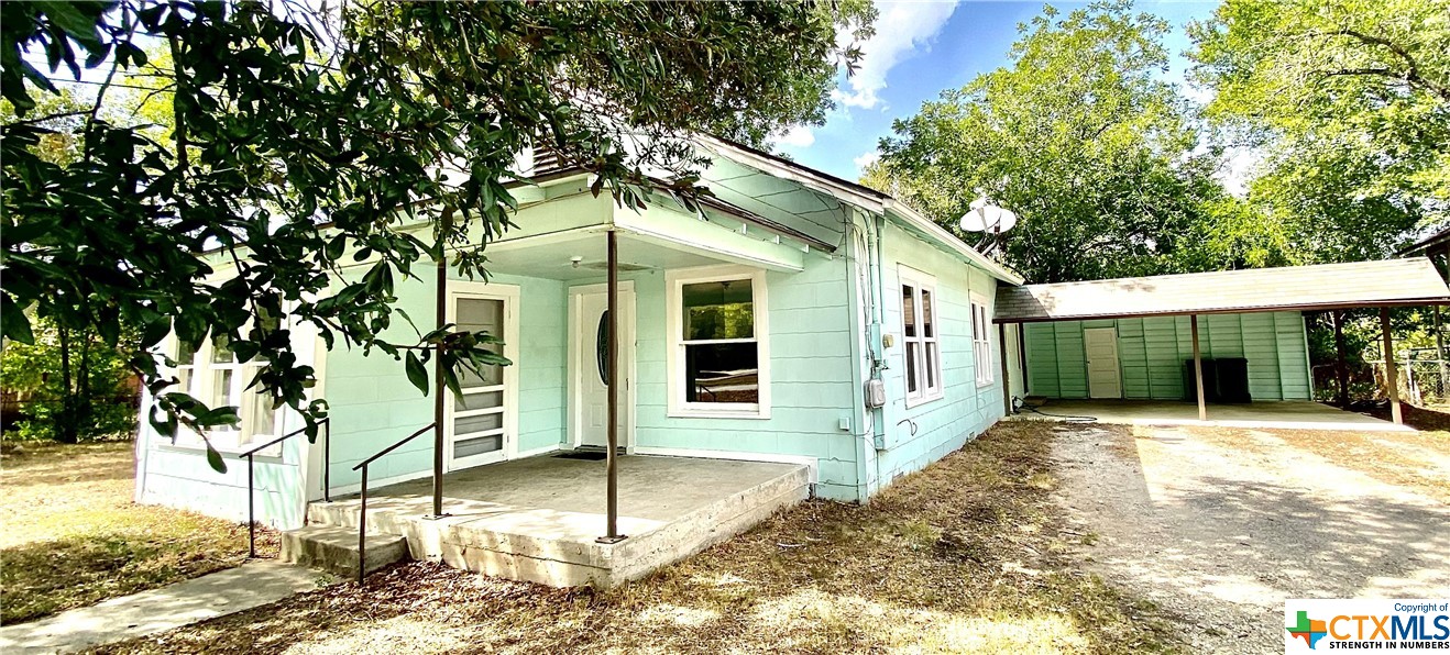 322 West Austin Street Luling, TX 78648 - Photo 1 of 21 a front view of a house with a porch