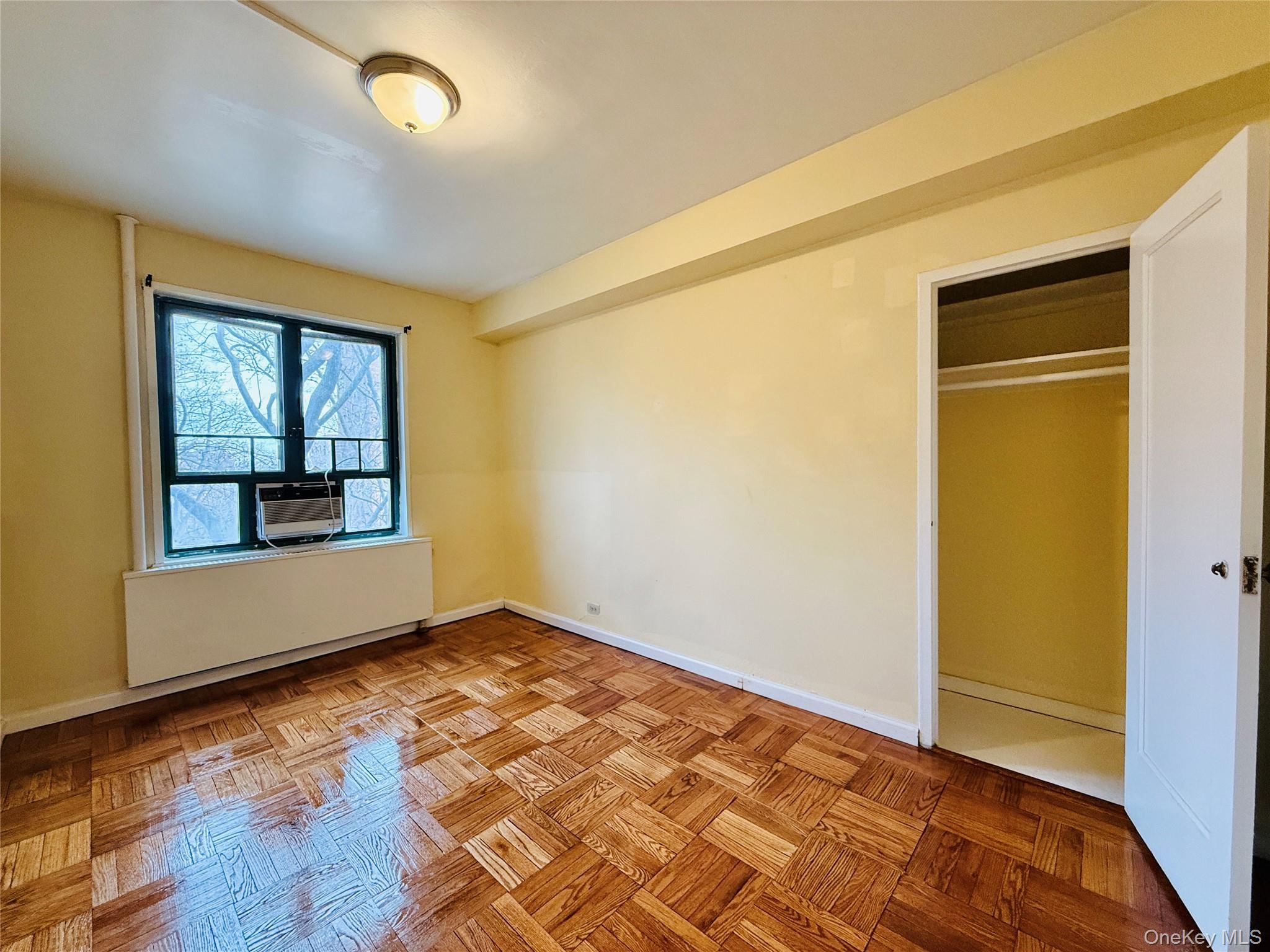 1576 Unionport Road, Unit 5F Bronx, NY 10462 - Photo 14 of 14 a view of an empty room with wooden floor and a window