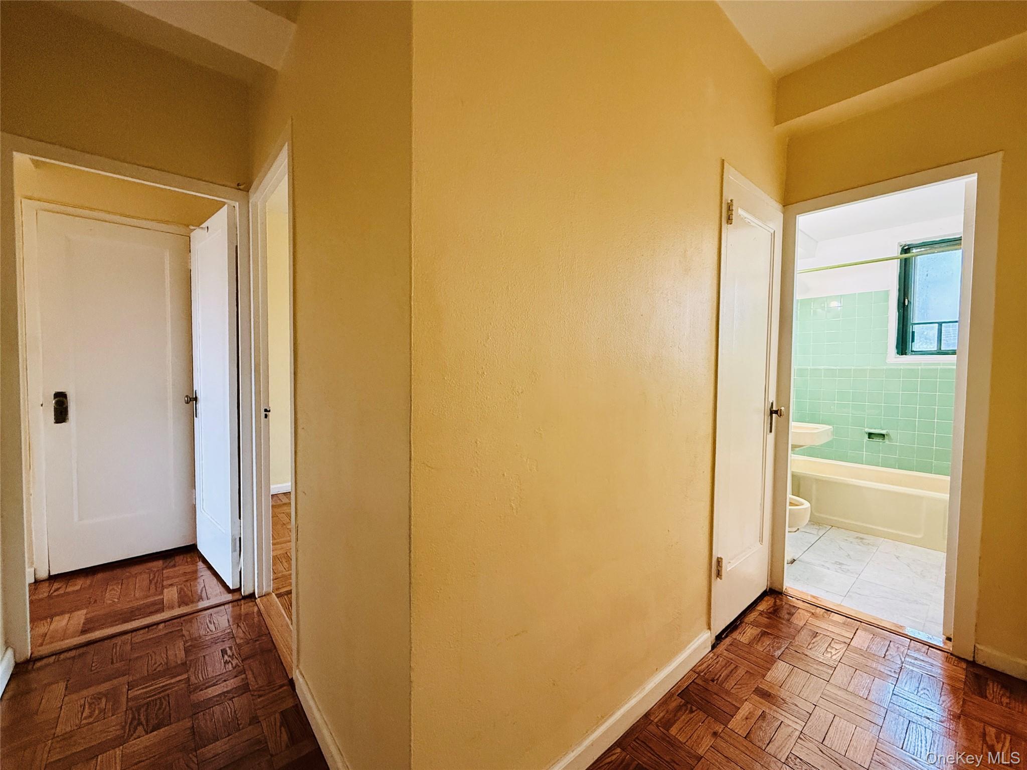 1576 Unionport Road, Unit 5F Bronx, NY 10462 - Photo 6 of 14 a view of a hallway with wooden floor and a bathroom