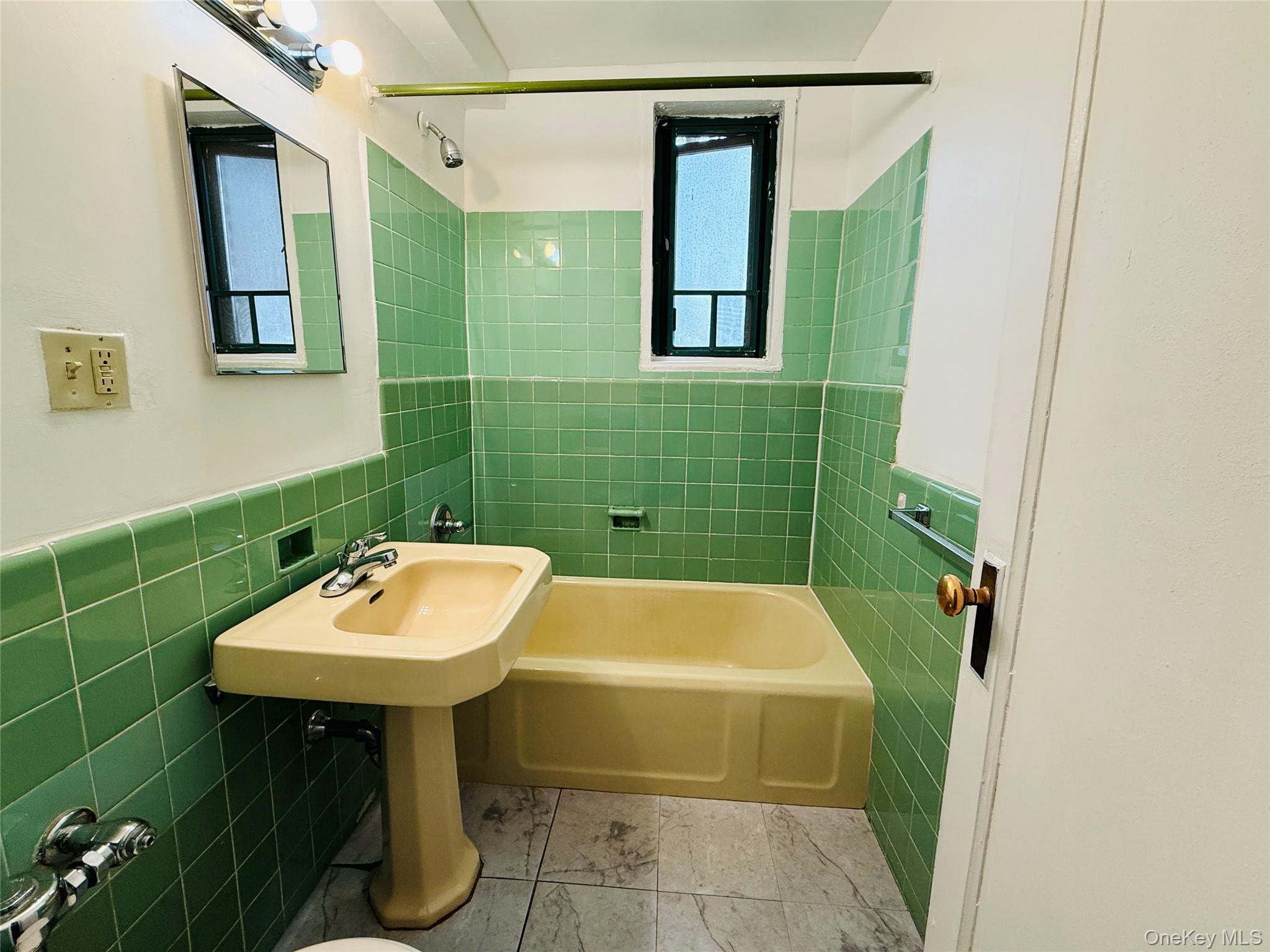 1576 Unionport Road, Unit 5F Bronx, NY 10462 - Photo 7 of 14 a bathroom with a sink and mirror
