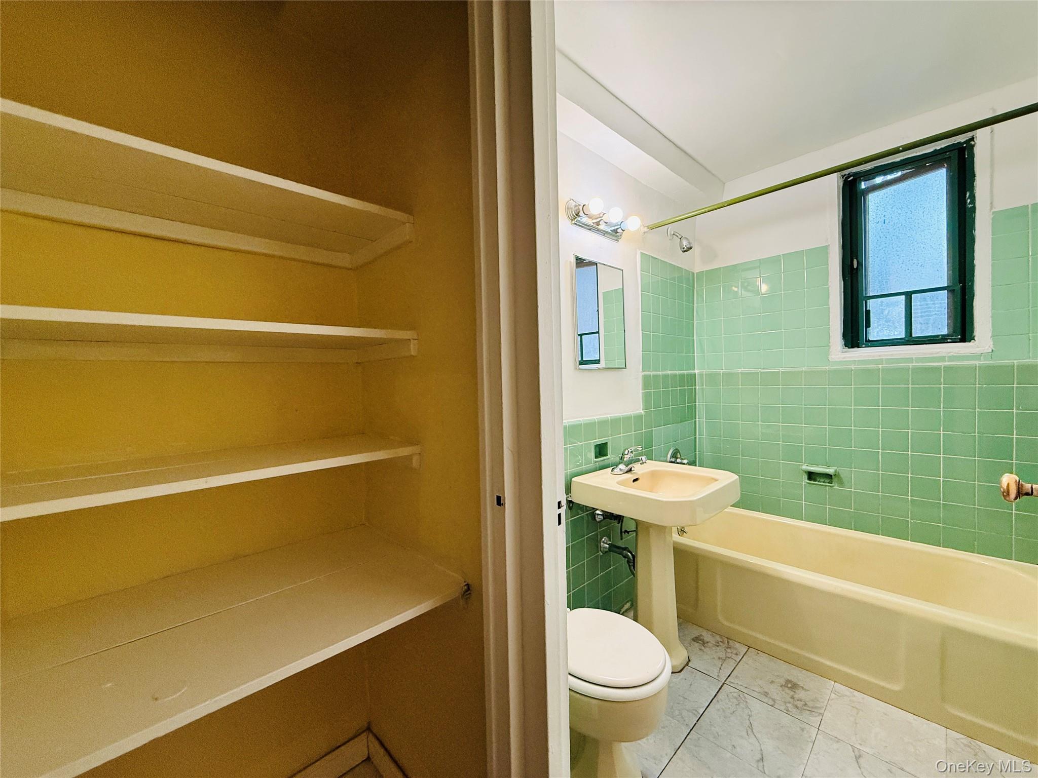 1576 Unionport Road, Unit 5F Bronx, NY 10462 - Photo 8 of 14 a bathroom with a sink a toilet and bathtub