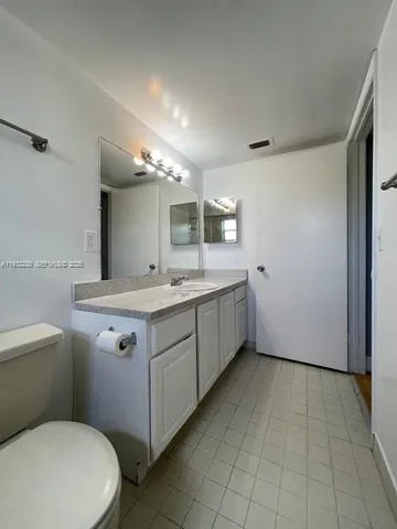a bathroom with a sink a toilet and mirror