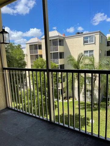 a view of a blue house with a floor to ceiling window and wooden fence
