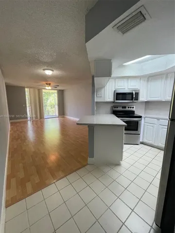 a kitchen with stainless steel appliances cabinets a sink and a stove