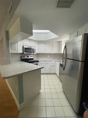 a kitchen with stainless steel appliances cabinets a sink and a counter top space