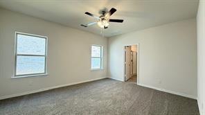 4304 Placer Mine Road Aubrey, TX 76227 - Photo 5 of 12 Spacious room featuring vaulted ceilings, neutral-toned carpeting, and two windows providing natural illumination