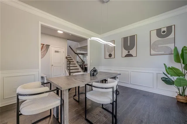 a bedroom with a bed and a large window with wooden floor