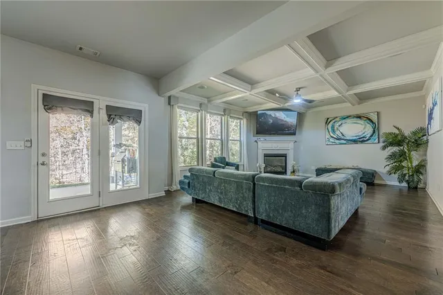 a kitchen with stainless steel appliances granite countertop a sink dishwasher and a dining table with wooden floor