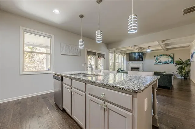 a bathroom with a granite countertop toilet sink and mirror