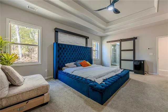 a bathroom with a granite countertop sink a toilet a mirror and shower