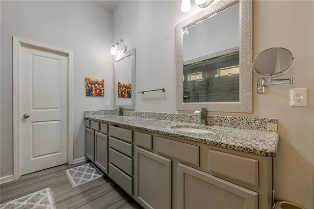 a bedroom with a bed and a chandelier fan