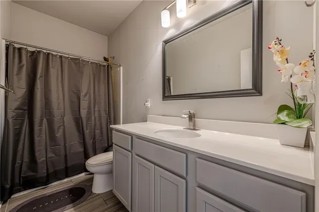 a view of an empty room with furniture and a window