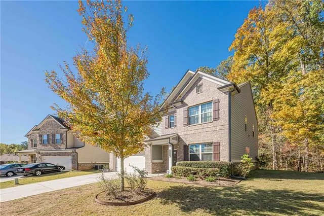 a front view of a house with a yard