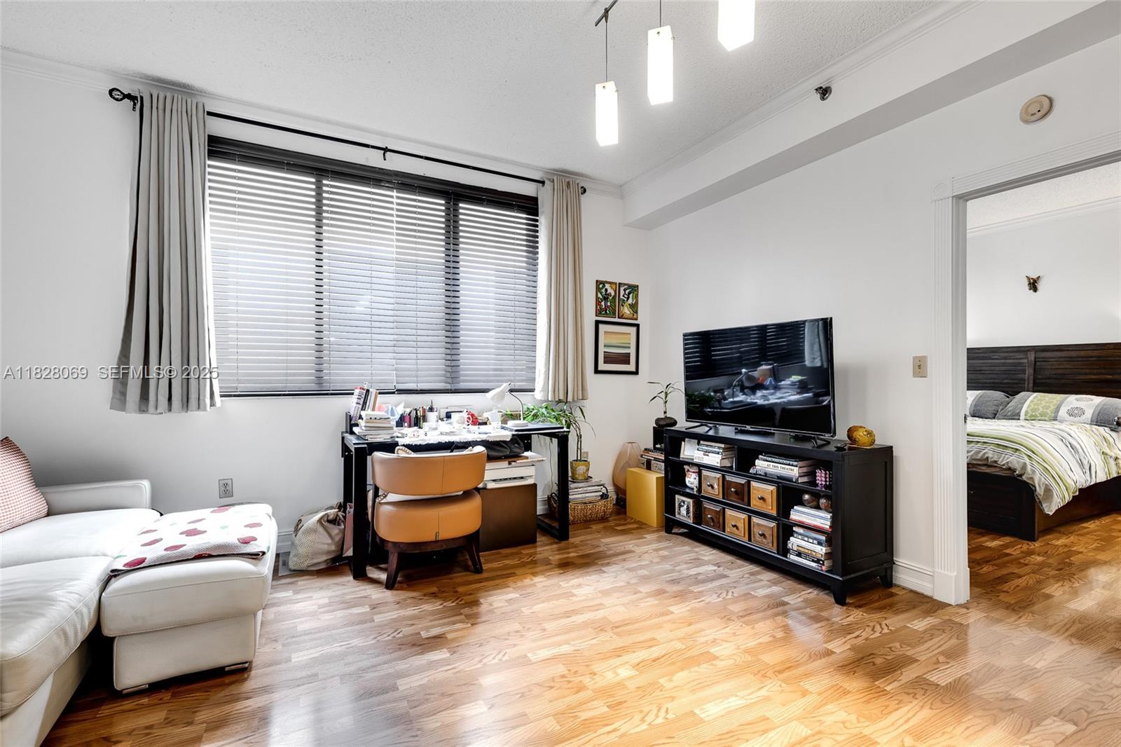 540 Brickell Key Drive, Unit 210 Miami, FL 33131 - Photo 1 of 12 a living room with furniture and a flat screen tv