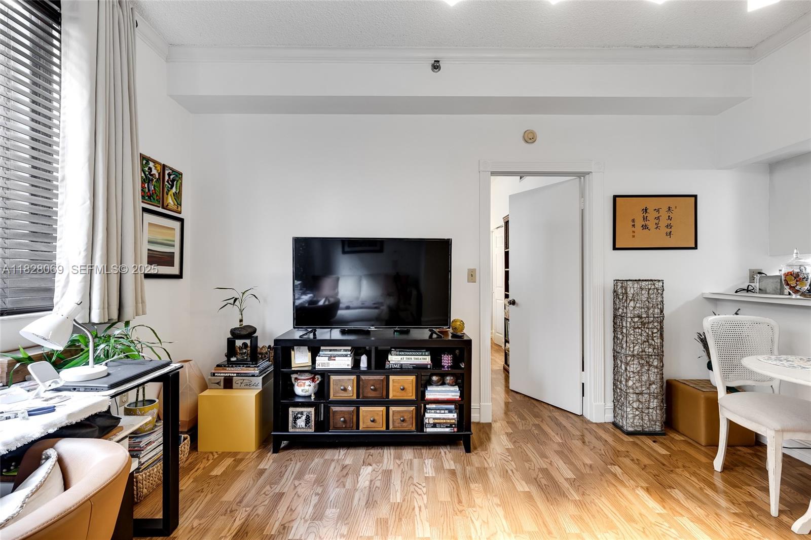 540 Brickell Key Drive, Unit 210 Miami, FL 33131 - Photo 11 of 12 a living room with furniture and a flat screen tv