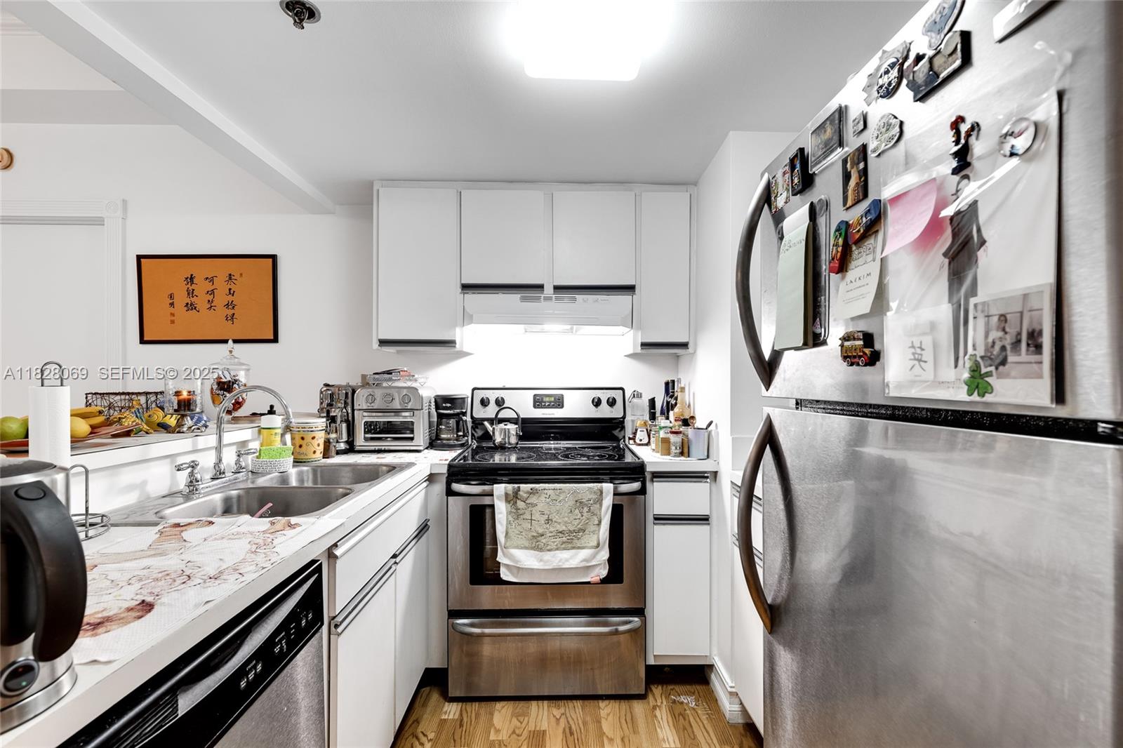 540 Brickell Key Drive, Unit 210 Miami, FL 33131 - Photo 5 of 12 a kitchen with stainless steel appliances granite countertop a stove and a sink