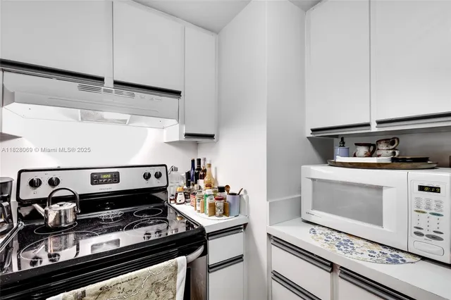 a stove top oven sitting inside of a kitchen