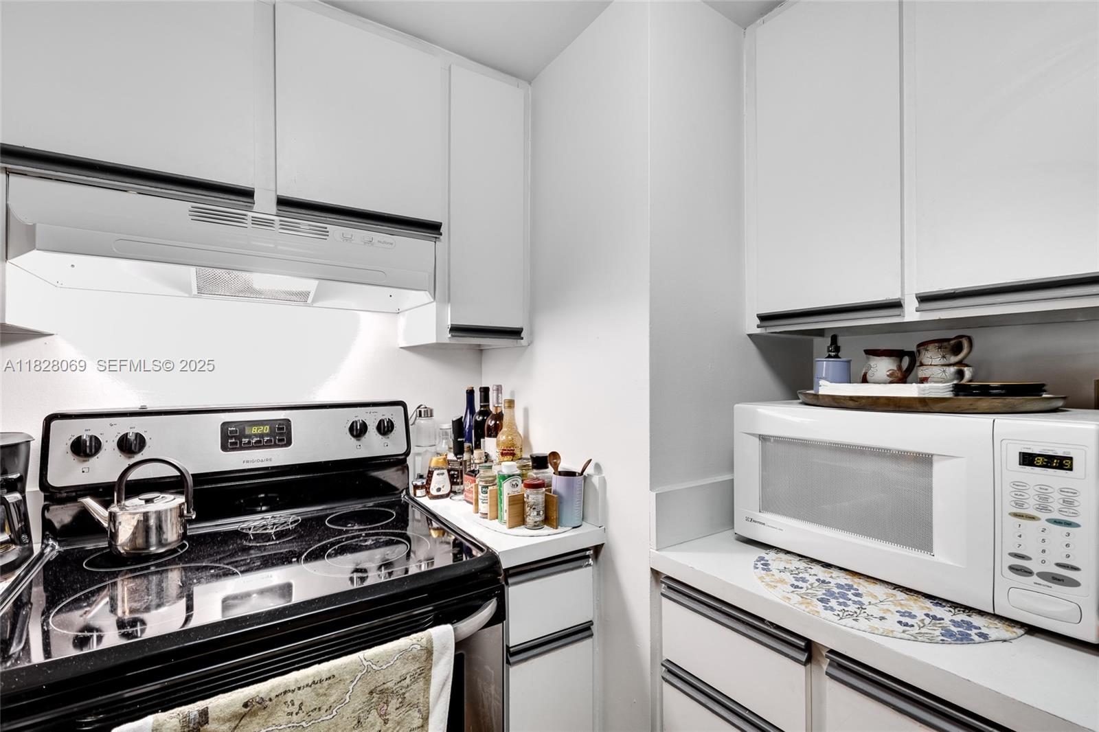 540 Brickell Key Drive, Unit 210 Miami, FL 33131 - Photo 7 of 12 a stove top oven sitting inside of a kitchen