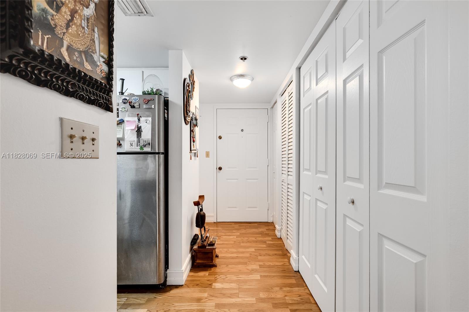 540 Brickell Key Drive, Unit 210 Miami, FL 33131 - Photo 8 of 12 a view of a hallway with wooden floor and staircase