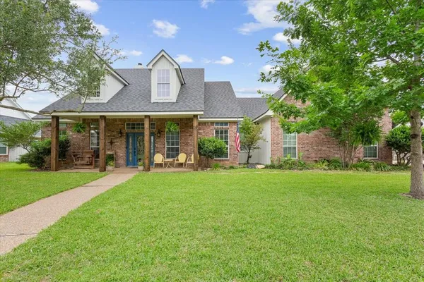 a front view of a house with a garden and porch