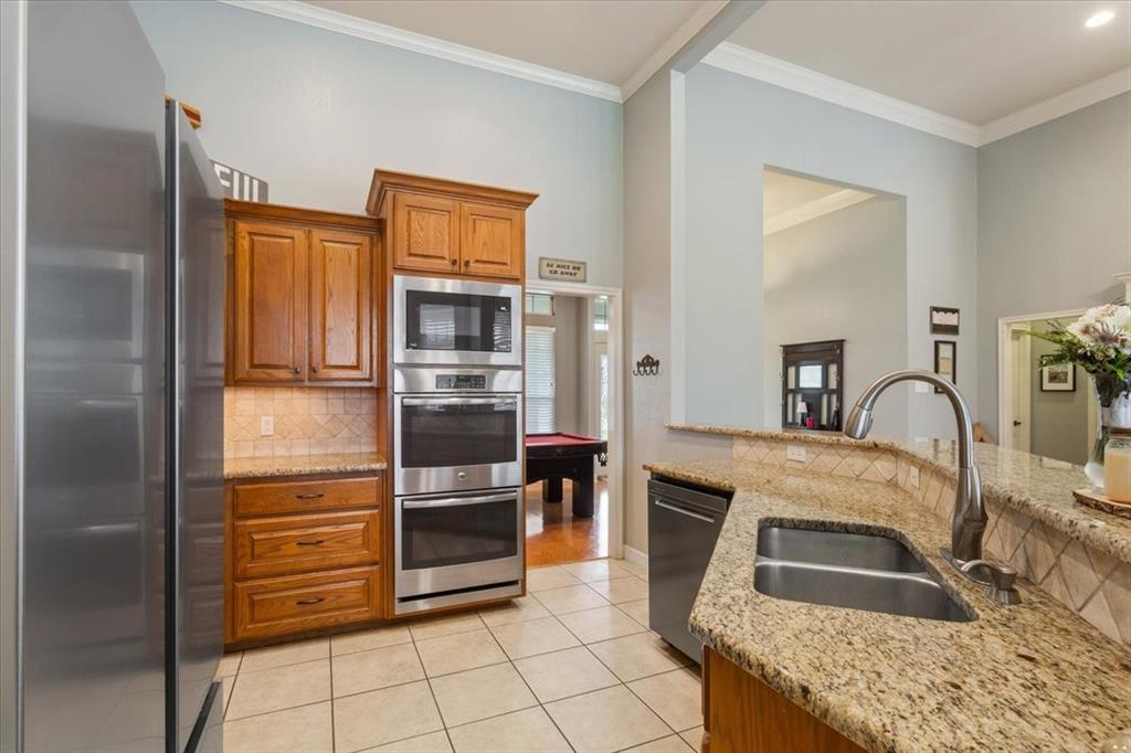 5616 Landsdown Drive Waco, TX 76708 - Photo 12 of 33 a kitchen with stainless steel appliances granite countertop a refrigerator and a stove
