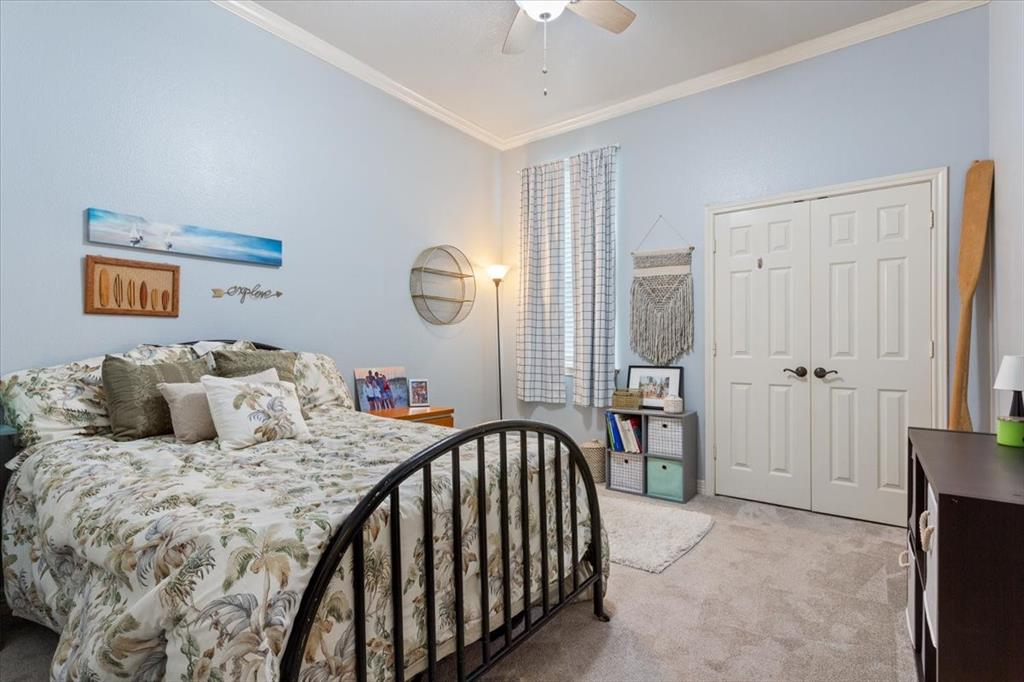 5616 Landsdown Drive Waco, TX 76708 - Photo 19 of 33 a bedroom with a large bed and a chandelier