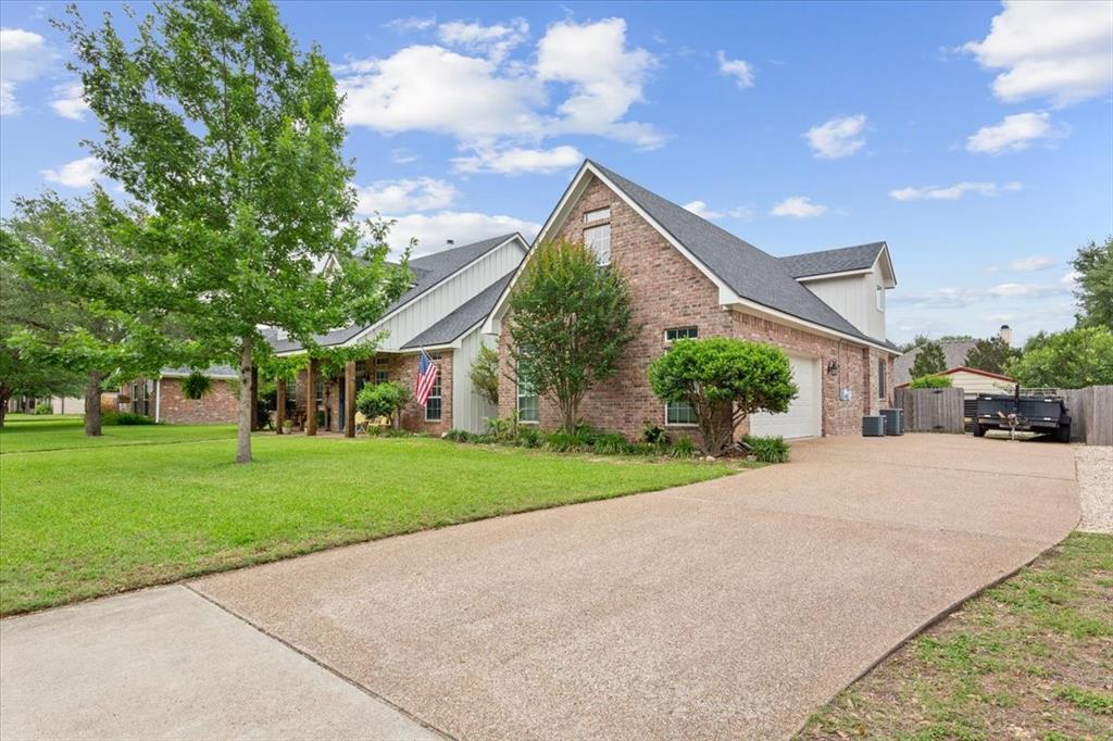 5616 Landsdown Drive Waco, TX 76708 - Photo 2 of 33 a front view of a house with a yard and garage