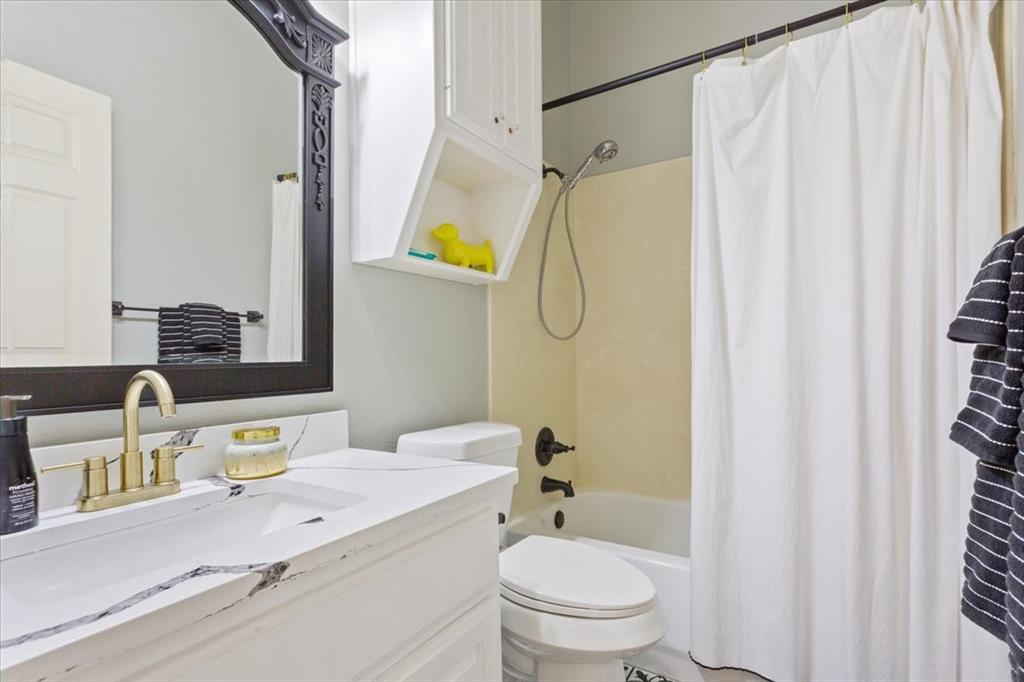 5616 Landsdown Drive Waco, TX 76708 - Photo 21 of 33 a bathroom with a granite countertop sink toilet and shower