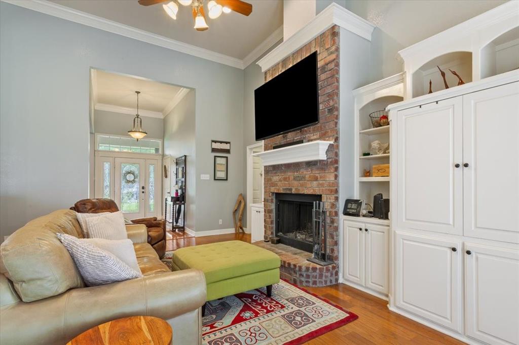 5616 Landsdown Drive Waco, TX 76708 - Photo 7 of 33 a living room with furniture a flat screen tv and a fireplace