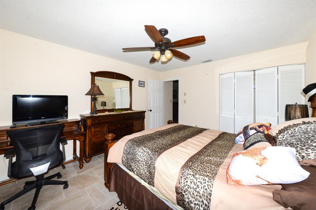 335 Coldeway Drive, Unit F21 Punta Gorda, FL 33950 - Photo 19 of 45 a bedroom with a bed and a flat screen tv