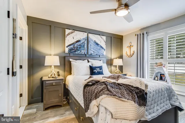 a bedroom with a bed and a painting on the wall