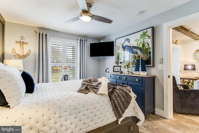 a bathroom with a granite countertop sink a toilet a mirror and shower