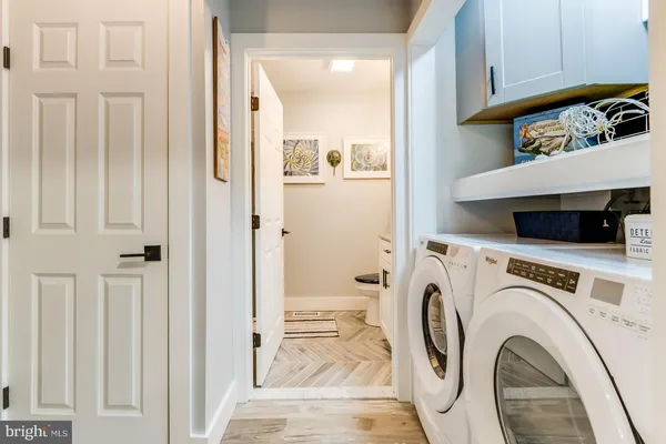 a view of a bedroom with wooden floor and furniture