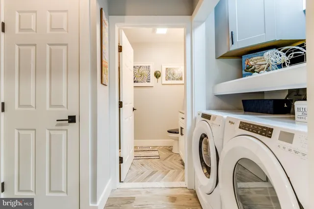 a view of a bedroom with wooden floor and furniture