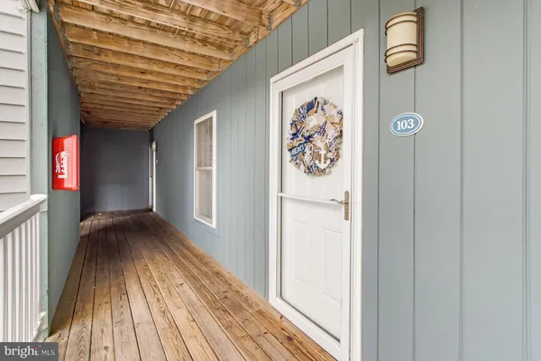 a kitchen with stainless steel appliances kitchen island granite countertop a sink a stove a refrigerator and cabinets