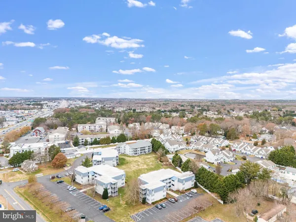 an aerial view of residential houses with yard