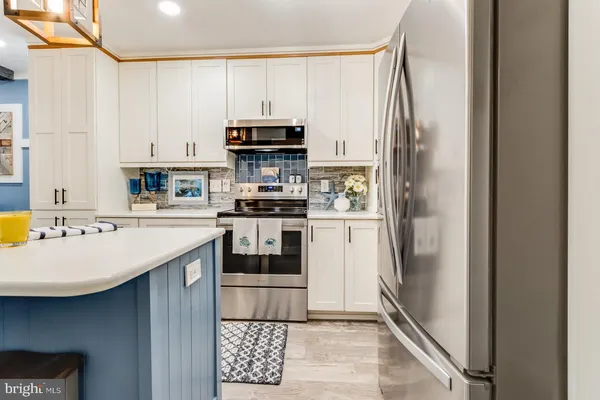a kitchen with stainless steel appliances granite countertop a stove and a sink
