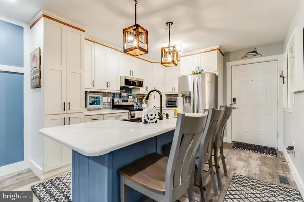 a view of a dining room with furniture and a chandelier