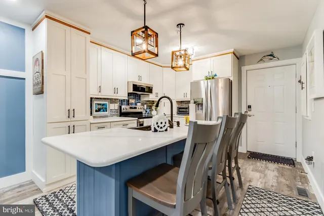 a view of a dining room with furniture and a chandelier