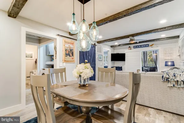 a view of a dining room with furniture and chandelier