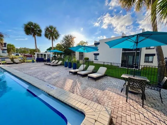 a view of a house with backyard and sitting area