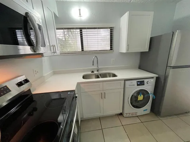 a utility room with closet dryer and washer