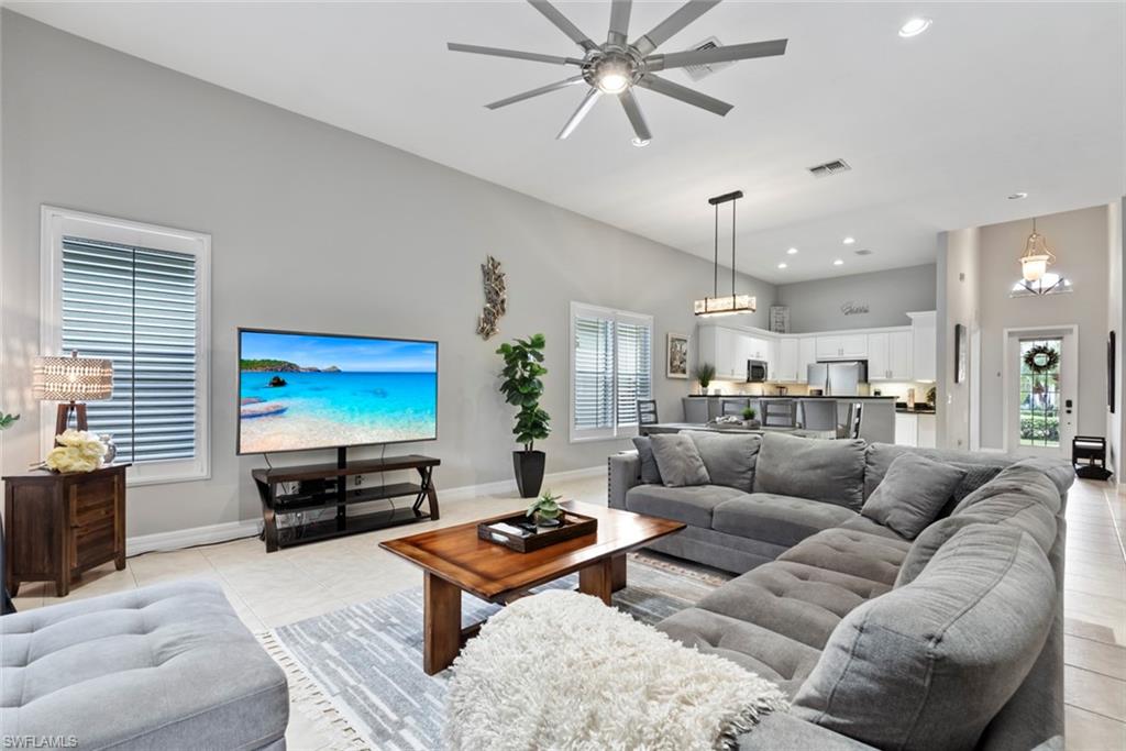 6051 Shallows Way Naples, FL 34109 - Photo 11 of 38 a living room with furniture kitchen view and a window