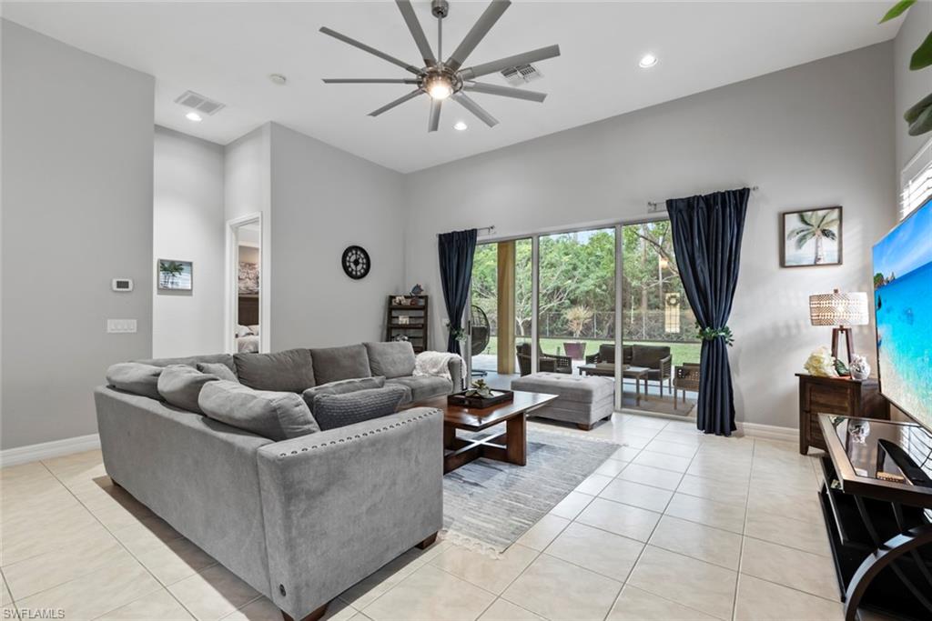 6051 Shallows Way Naples, FL 34109 - Photo 12 of 38 a living room with furniture and large windows