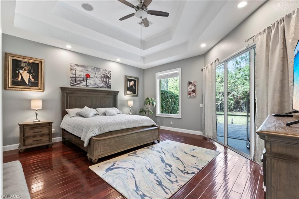 6051 Shallows Way Naples, FL 34109 - Photo 21 of 38 a bedroom with a large bed and a window